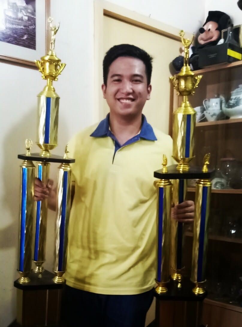 Jeremy holding his ICC multimedia championship trophies